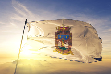 Zacatecas state of Mexico flag waving on the top sunrise mist fog
