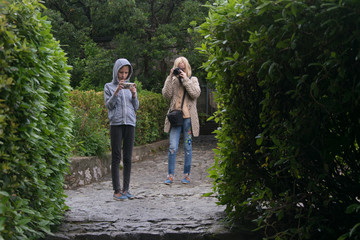 Mother makes photo of teenager daughter in park.