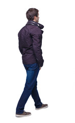 Naklejka premium Side view of going handsome man in jeans and jacket.