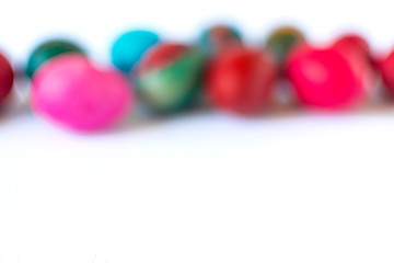 Blurred easter eggs on white background