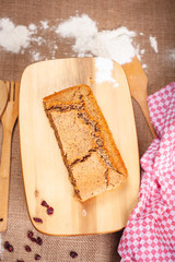 Piece of homemade semolina cake on wooden cutting board. Top view. Close up