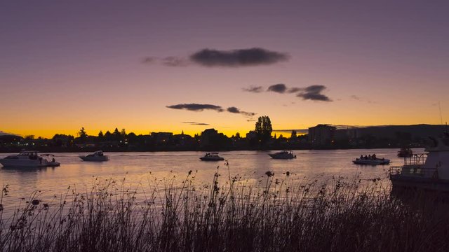 Time lapse at sunset on the riverside Callecalle in the city of Valdivia. Boats await the nautical parade for the anniversary of the city