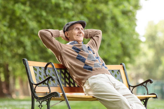 Elderly man enjoying a day on a wooden bench