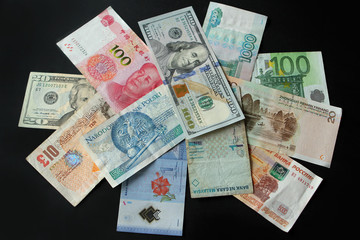 Closeup of banknotes of different states on a dark background