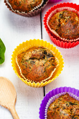 Muffins with basil and spinach on wooden rustic table. Close up. Top view