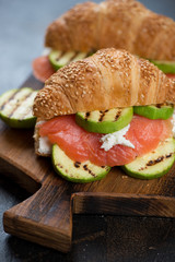Close-up of croissants with trout fillet, grilled zucchini and ricotta cheese, studio shot