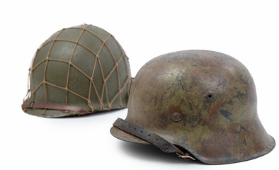 German and U.S  World War Two military helmets, battle of Normandy 1944 - obrazy, fototapety, plakaty