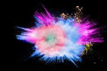 Colorful powder explosion in Happy Holi Festival. Multicolored dust particle splashing.