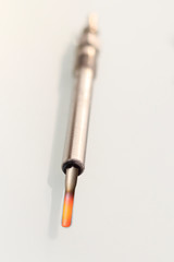 candle in a diesel engine. on a white background. do not isolate the red tip