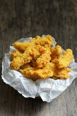 Chicken strips on wooden table