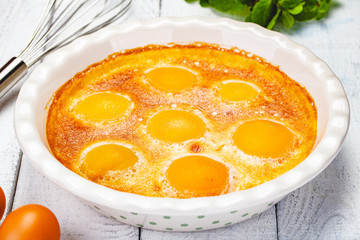 Peach Clafoutis in ceramic pie dish. Close up