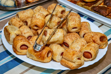 Preparing hot dogs' puff pastry