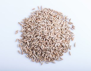 Heap of rye grains isolated on white background.
