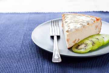 Homemade cottage cheese cake with kiwi fruit and cream