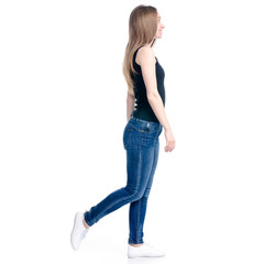 Woman in jeans walking goes on white background isolation, back view