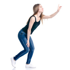 Woman in jeans standing showing pointing on white background isolation