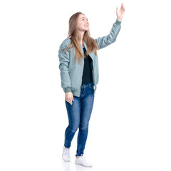 Woman in jeans and green jacket walking goes smiling showing pointing on white background isolation
