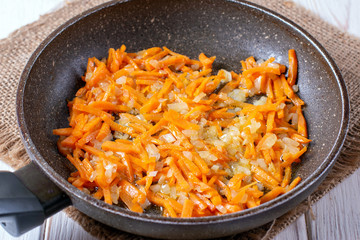 Fried onions and carrots, filling soup, garlic, homemade food