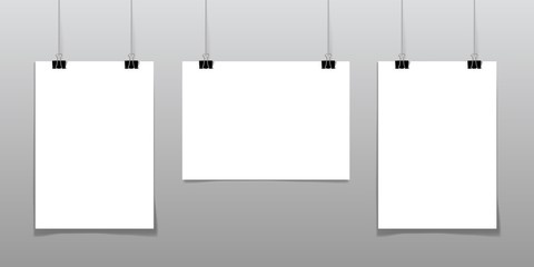 Set of 3 blank posters hanging on thread with clips