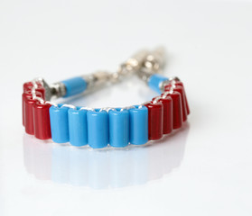 Stone bracelet red with white background. 