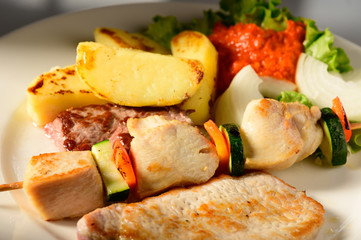 Mixed Grilled meat and vegetables decorated on a plate ready to be served in restaurant