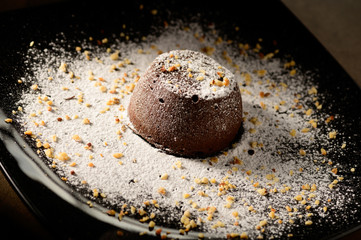 Chocolate souffle home, baked in oven from hight quality cocoa and decorated on a plate ready to be served in restaurant