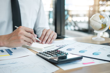 Businessman accountant working analyzing and calculating expense financial annual financial report balance sheet statement, doing finance making notes on report