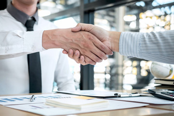 Finishing up a conversation after collaboration, handshake of two business people after contract agreement to become a partner, collaborative teamwork