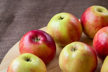 Fototapeta na wymiar Red apples on wooden background, natural food.