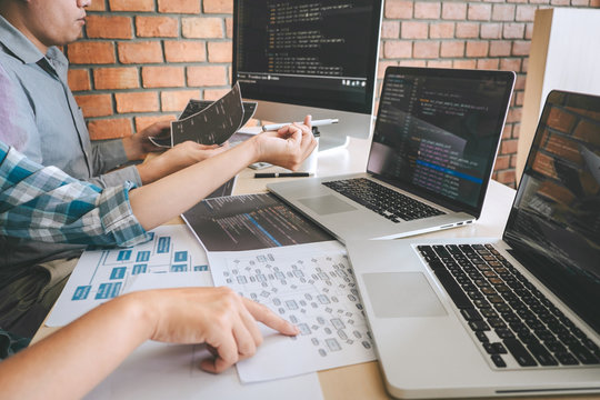 Developer programmer meeting and brainstorming and programming in website
