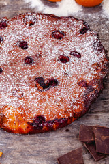 Brownie with cherries on wooden rustic table. Close up