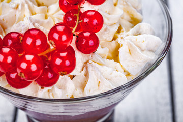 Homemade chocolate mousse in portion glass on wooden background. Close up
