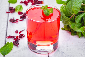 Jelly with hibiscus in portion glass on wooden background. Close up