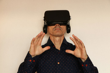 Close-up of a man in a black T-shirt with glasses of virtual reality.