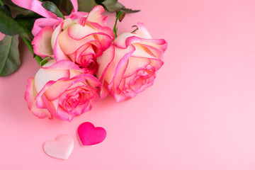 beautiful flowers bouquet with garden pink creamy rose and hearts on pink festive background, concept of Valentines day
