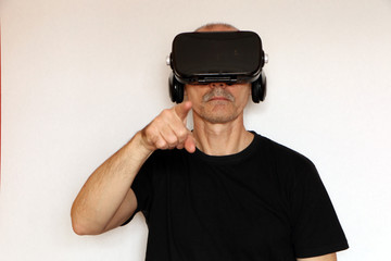 Close-up of a man in a black T-shirt with glasses of virtual reality.