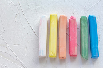 colored crayons on white background with copy space