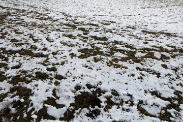 Footprint of a human in the snow in mountains after Winter in Spring
