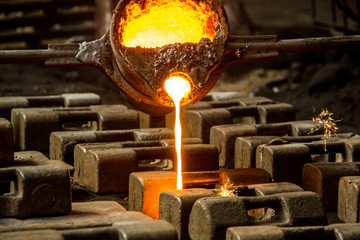 metal casting process with red high temperature fire in metal part factory