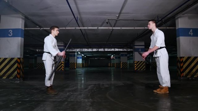 Two men greeting each other before the training sword fight and starts training