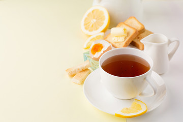 Breakfast with boiled egg, toasts, tea