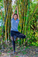 Asian woman yoga on the background of bamboo