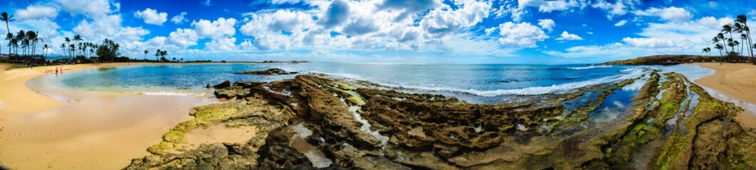 Fototapeta na wymiar pano of beach with rocks and sand on left
