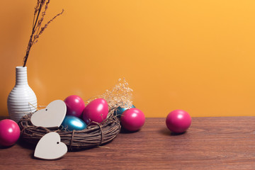 colorful easter eggs food vintage with wood vine and flower on yellow background
