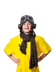 Young boy with yellow T-shirt, aviator goggles, plane and world ball smiling