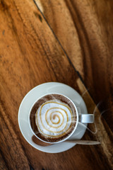 White coffee cup Placed on the wood floor, Fragrant coffee aroma Invited to feel like drinking,