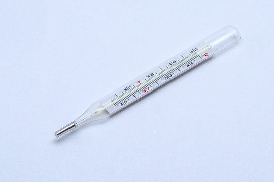 old mercury medical thermometer for measuring human body temperature on a white background, close-up