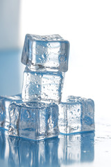 vertical stack of ice cubes on wet surface