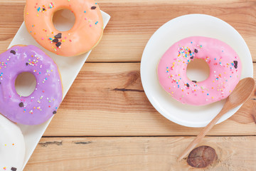Sweet donuts on wooden background.