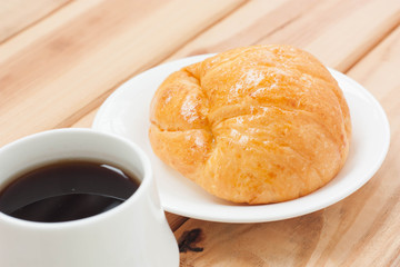 Croissant and black coffee hot morning beverage or break time.